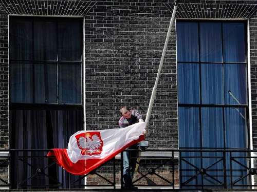 Mise en berne du drapeau national polonais, par un membre de l'ambassade de Pologne à Londres