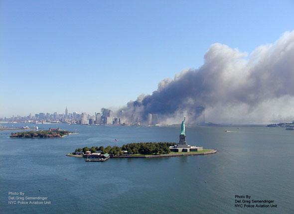 Statue de la Liberté dans la rade de New York sur fond de tours du WTC en flammes le 11/09/2001